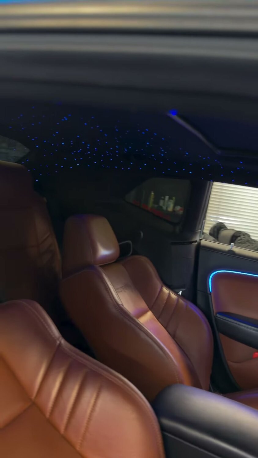 Cognac leather interior with starlight headliner and ambient lighting